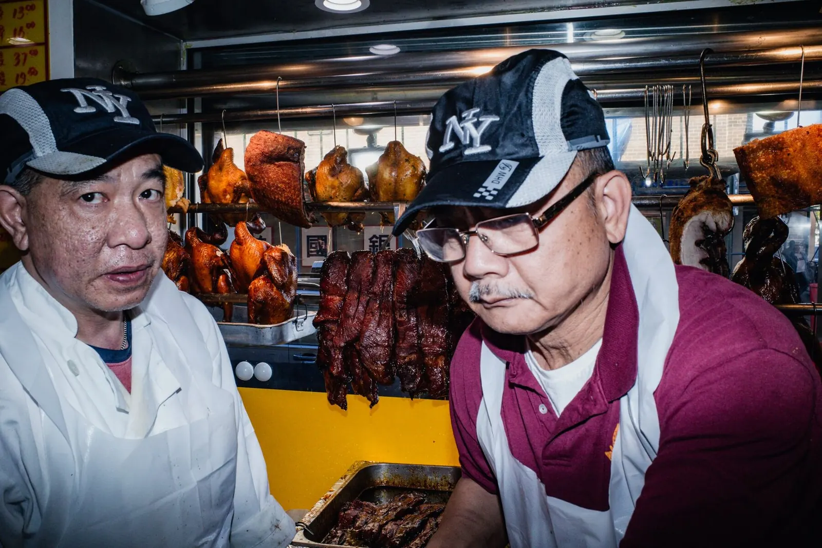 Two roast meat cooks at the Noodletown BBQ counter